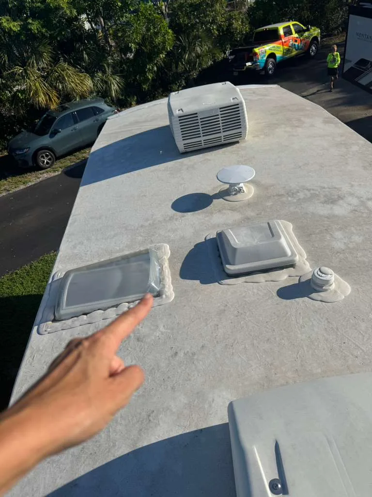 Technician repairing an RV roof leak