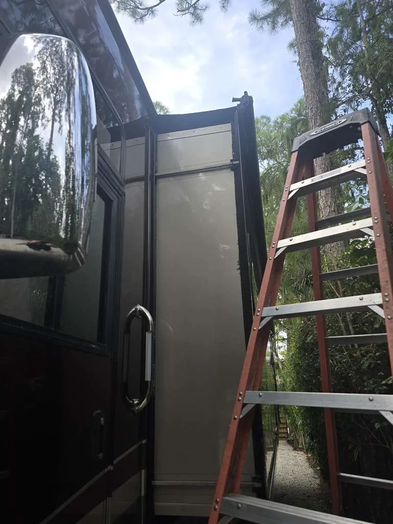 Technician repairing a stuck RV slide-out